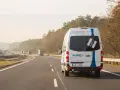 Biały bus AR-SPEED jedzie autostradą. Zastanawiasz się, ile kosztuje bus do Niemiec? Sprawdź na ar-speed.pl.