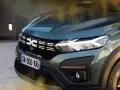 Nowy Dacia Sandero Stepway w zielonym kolorze, z charakterystycznym logo i nowoczesnymi światłami LED.