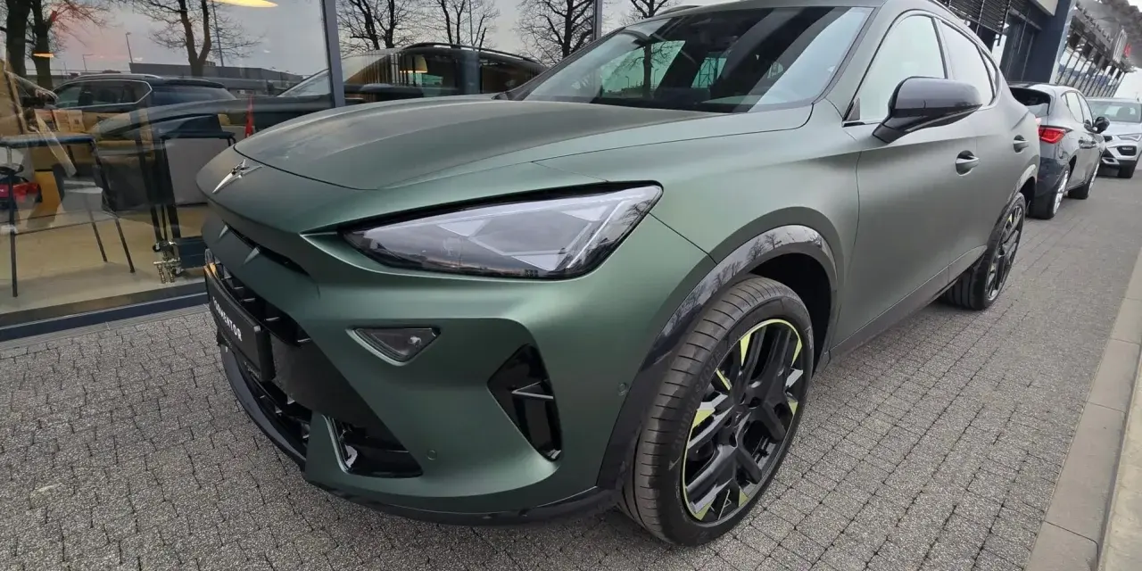 Nowa Cupra w matowym, zielonym kolorze prezentuje się imponująco na tle salonu.