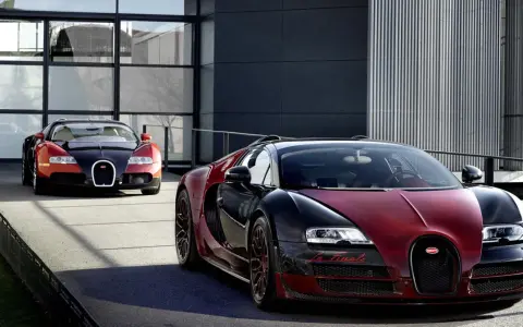 Dwa Bugatti Veyron, jeden czerwono-czarny z napisem "La Finale", gotowe do osiągnięcia 100 km/h.