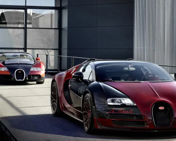 Dwa Bugatti Veyron, jeden czerwono-czarny z napisem "La Finale", gotowe do osiągnięcia 100 km/h.