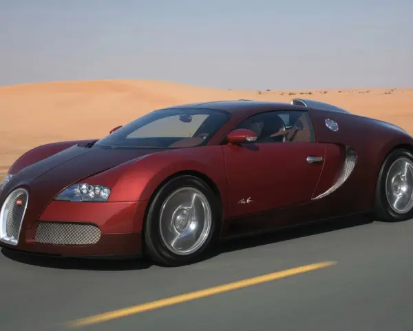 Czerwone Bugatti Veyron sunie po pustynnej drodze. Zastanawiasz się, ile kosztuje taki luksus?