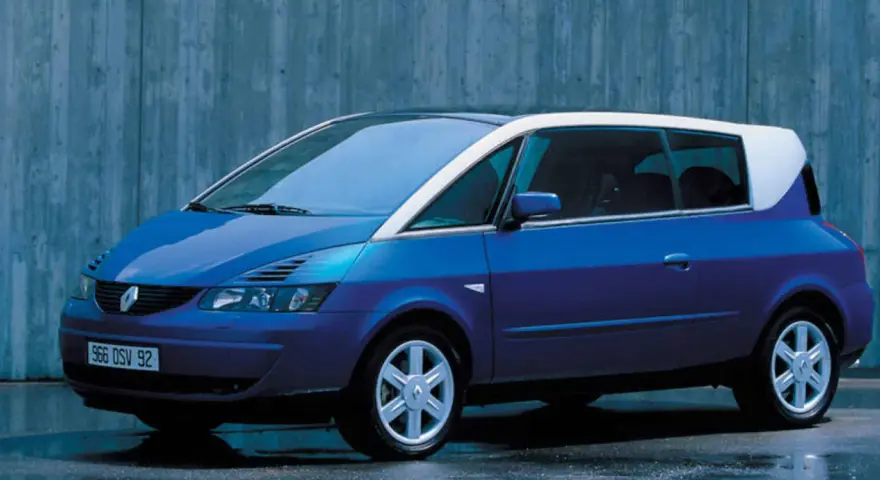 Niebieski Renault Avantime z białym dachem, stojący na tle betonowej ściany.