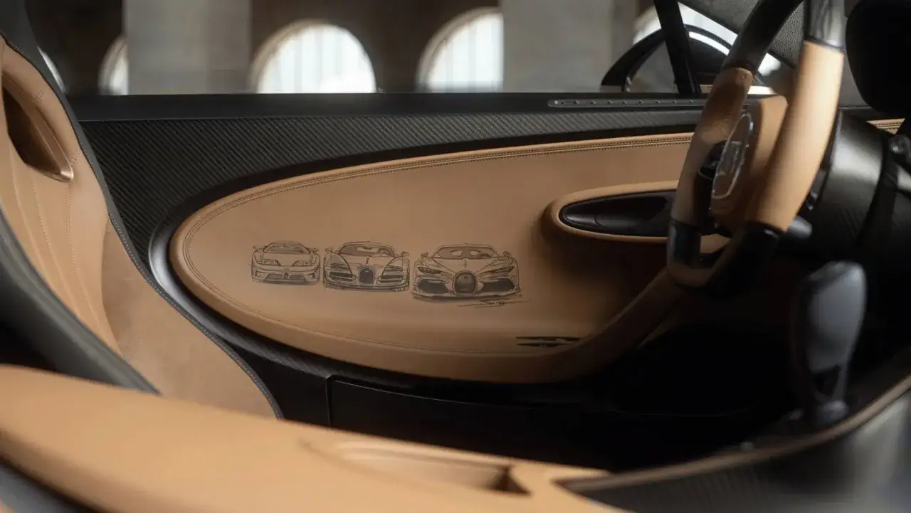 Wnętrze Bugatti Chiron z wytłoczonymi szkicami samochodów. Skóra i włókno węglowe tworzą luksusowy kokpit.